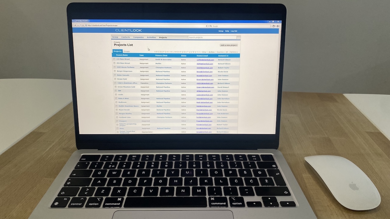 ClientLook CRM interface displaying a project list with names, statuses, primary clients, and assigned team members.