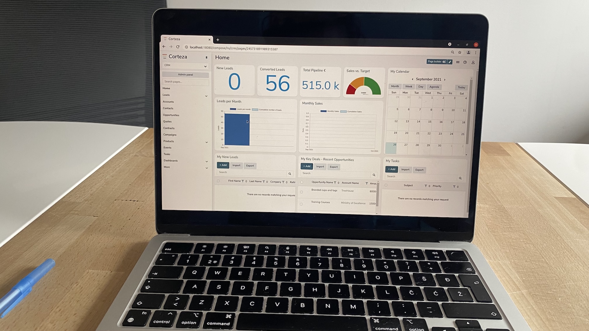 Corteza open-source CRM dashboard with lead metrics, sales data, and calendar view, displayed on a laptop screen