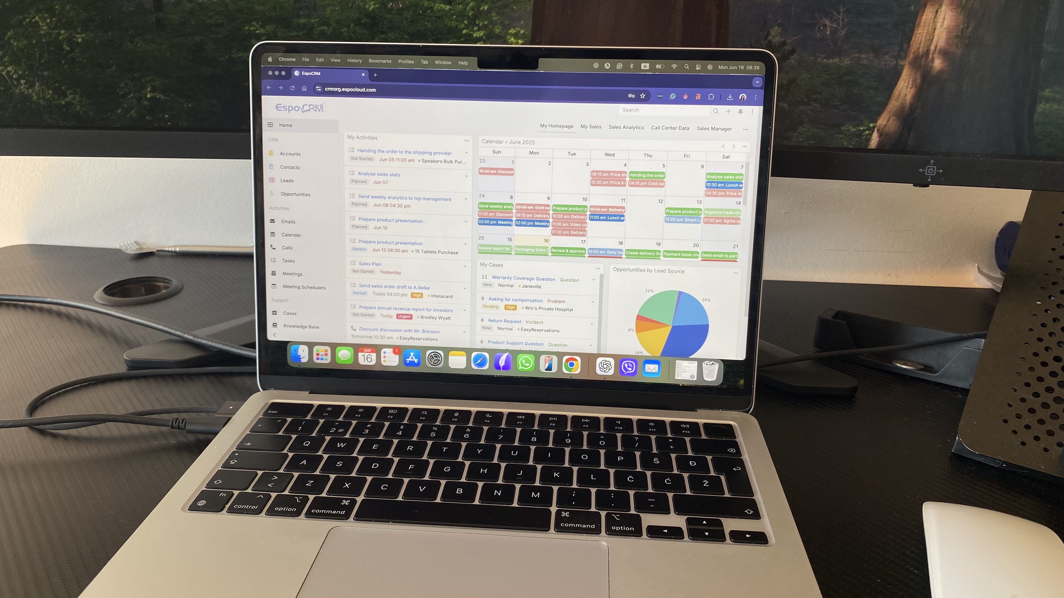 EspoCRM dashboard with calendar, task list, cases panel, and lead source chart on main overview screen.