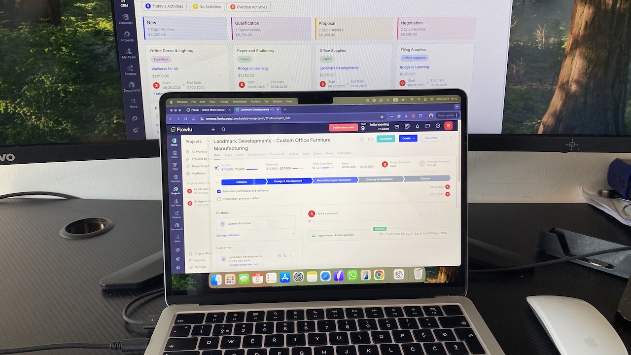 MacBook Pro laptop displaying the Flowlu software dashboard with project tasks, budget tracking, and team progress views