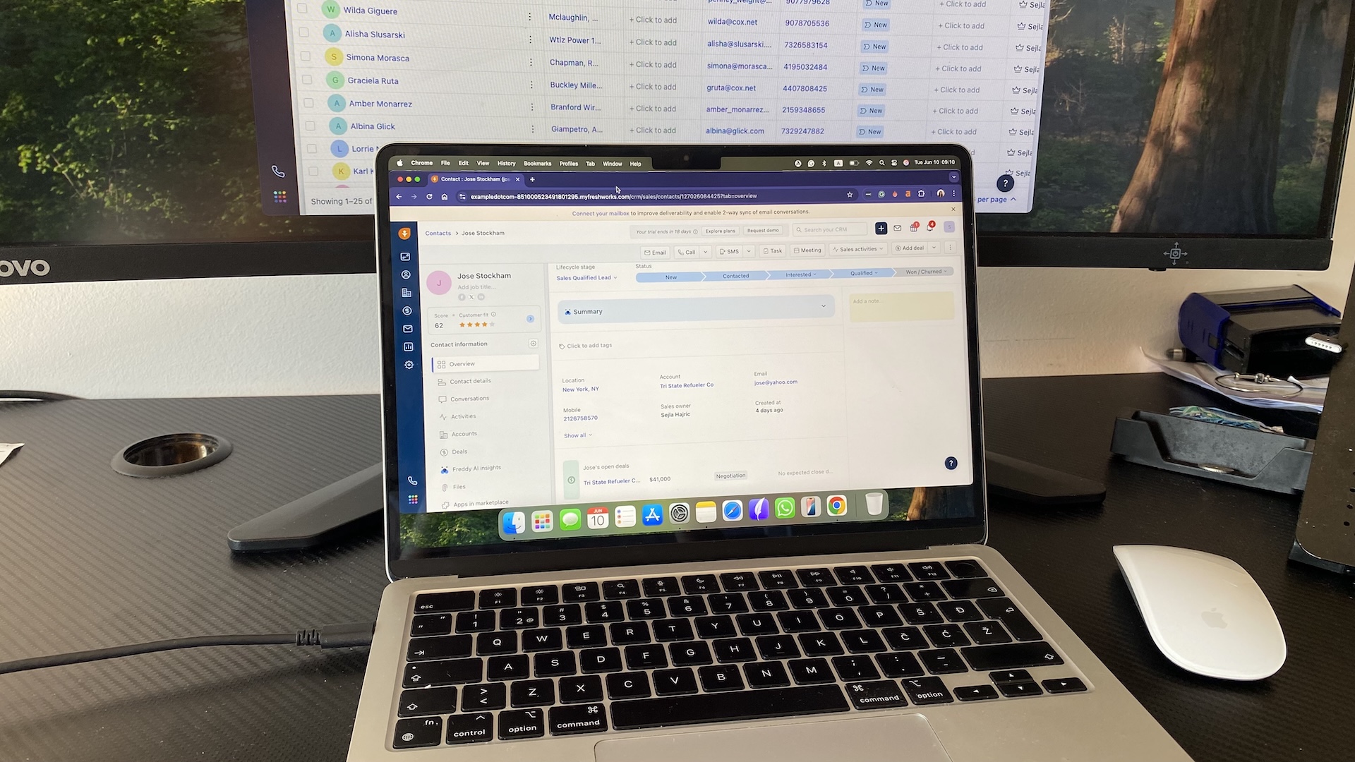 Contact record view in Freshsales CRM showing lead details, deal progress, and activity history on a MacBook screen.