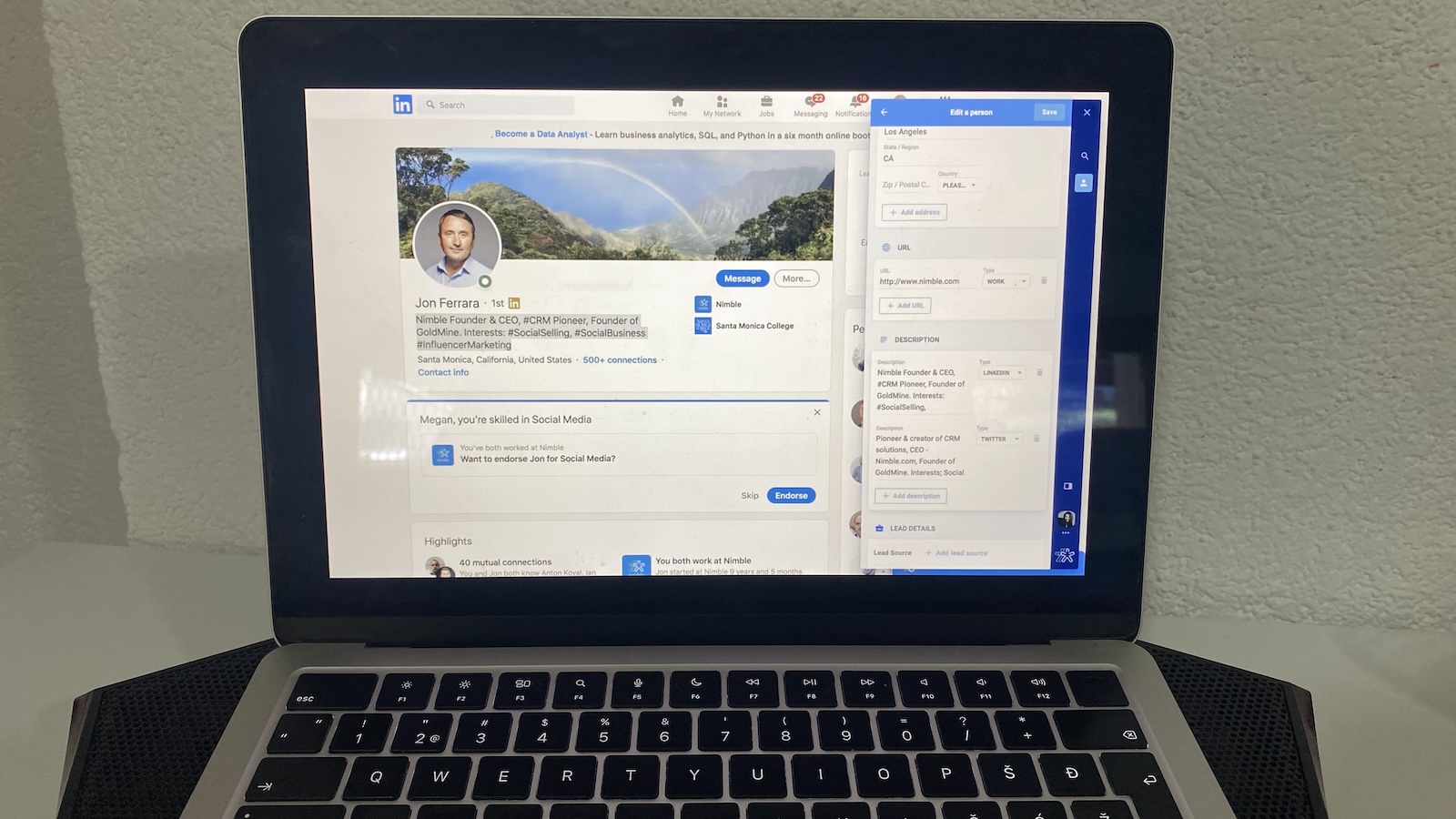 Laptop screen showing LinkedIn profile of Jon Ferrara with Nimble Prospector sidebar open on the right.