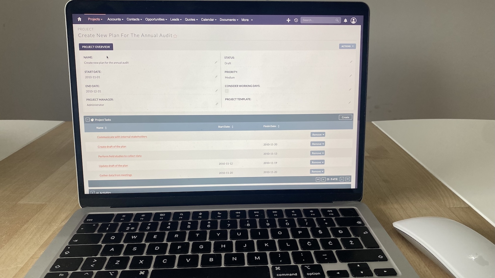 Project overview screen in SuiteCRM showing project status, manager, and task list with dates and remove buttons.